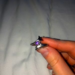 Silver dolphin ring with purple gem.